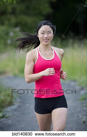 Korean woman running on remote path View Large Photo Image Stock Image - Korean woman running on remote path. Fotosearch