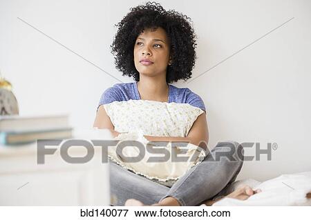 Lonely woman hugging pillow on bed View Large Photo Image Stock Photo - Lonely woman hugging pillow on bed. Fotosearch