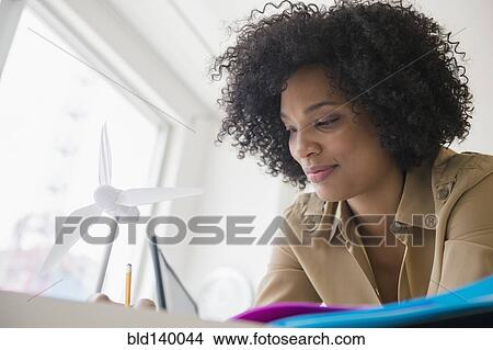 Picture - Low angle view of businesswoman working at desk. Fotosearch