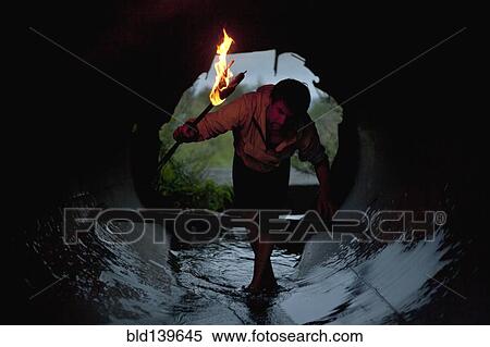 Mari man holding torch in tunnel View Large Photo Image Stock Photography - Mari man holding torch in tunnel. Fotosearch