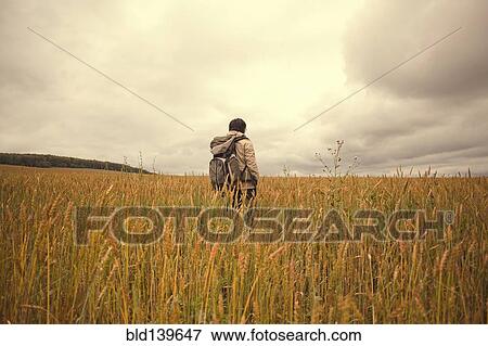 Stock Photo - Mari man standing in tall grass in rural field. Fotosearch