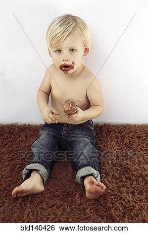 Messy Caucasian boy eating chocolate ice cream cone View Large Photo Image Stock Photograph - Messy Caucasian boy eating chocolate ice cream cone. Fotosearch