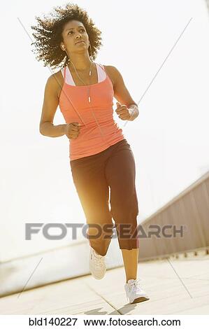 Mixed race woman jogging outdoors View Large Photo Image Stock Photo - Mixed race woman jogging outdoors. Fotosearch