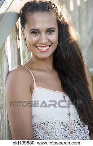 Mixed race woman sitting on wooden steps View Large Photo Image Stock Image - Mixed race woman sitting on wooden steps. Fotosearch
