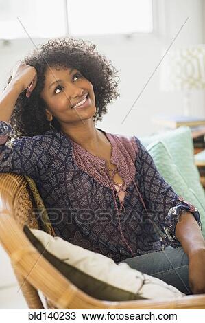 Mixed race woman smiling in living room View Large Photo Image Stock Image - Mixed race woman smiling in living room. Fotosearch