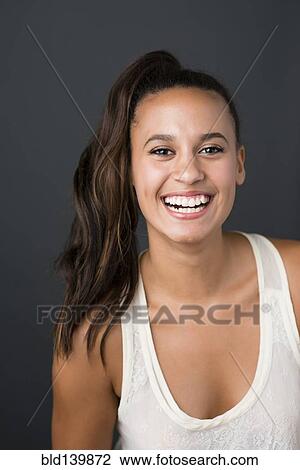 Stock Image - Mixed race woman smiling. Fotosearch