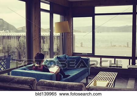 Mixed race woman using digital tablet in living room View Large Photo Image Stock Photography - Mixed race woman using digital tablet in living room. Fotosearch