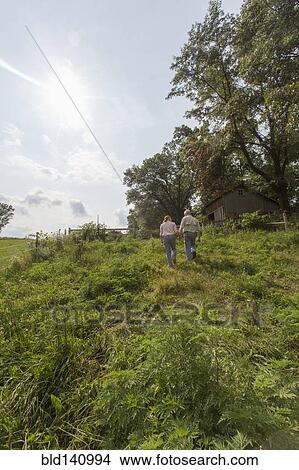 Older Caucasian couple walking on farm View Large Photo Image Picture - Older Caucasian couple walking on farm. Fotosearch