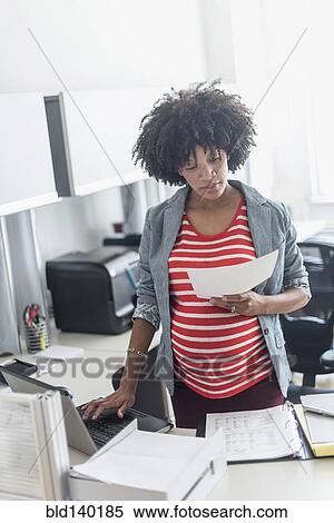 Pregnant African American businesswoman working in office View Large Photo Image Stock Photography - Pregnant African American businesswoman working in office. Fotosearch