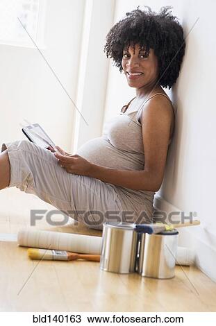 Pregnant African American mother examining paint swatches for nursery View Large Photo Image Stock Image - Pregnant African American mother examining paint swatches for nursery. Fotosearch