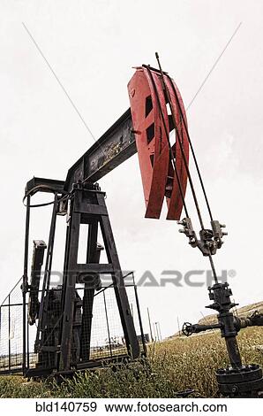 Pump working in oil field in remote landscape View Large Photo Image Stock Photo - Pump working in oil field in remote landscape. Fotosearch
