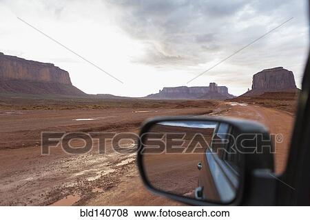 Stock Photo - Rock formations and desert landscape viewed from car, Monument Valley, Utah, United States. Fotosearch