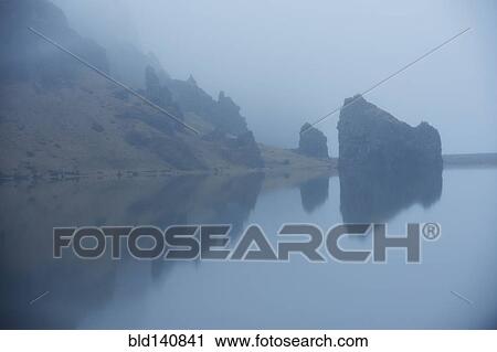 Rock formations and remote misty lake View Large Photo Image Stock Image - Rock formations and remote misty lake. Fotosearch