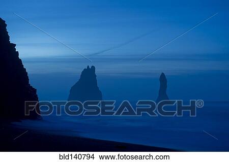 Rock formations in ocean at misty beach View Large Photo Image Picture - Rock formations in ocean at misty beach. Fotosearch