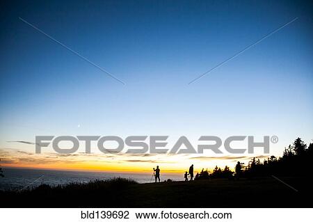 Silhouette of family on rural hillside at sunset View Large Photo Image Stock Image - Silhouette of family on rural hillside at sunset. Fotosearch