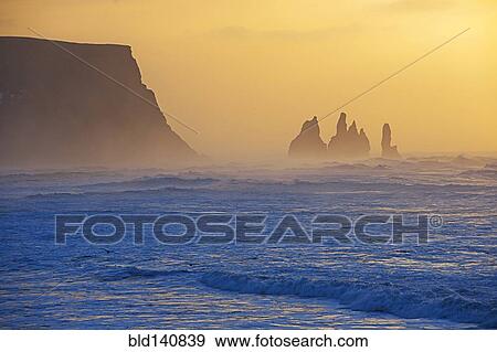 Silhouette of rock formations in misty ocean View Large Photo Image Stock Photo - Silhouette of rock formations in misty ocean. Fotosearch