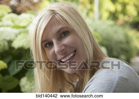 Smiling Caucasian woman smiling outdoors View Large Photo Image Stock Image - Smiling Caucasian woman smiling outdoors. Fotosearch
