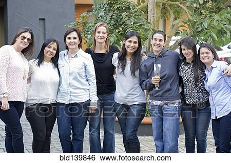 Stock Photograph - Smiling friends standing outdoors. Fotosearch