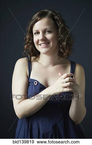 Stock Photo - Smiling woman posing in studio. Fotosearch