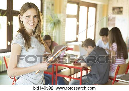 Student carrying notebooks in school cafeteria View Large Photo Image Stock Image - Student carrying notebooks in school cafeteria. Fotosearch