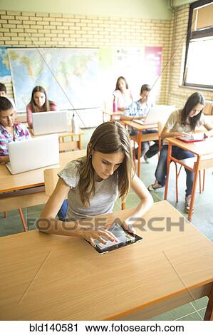 Student using digital tablet in classroom View Large Photo Image Stock Image - Student using digital tablet in classroom. Fotosearch