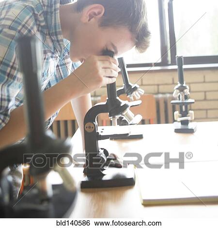 Stock Photograph - Student using microscopes in science class. Fotosearch