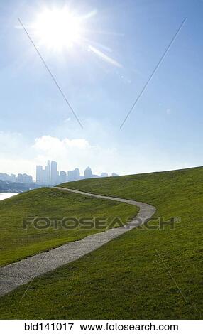Sun shining over paved road on grassy hillside, Seattle, Washington, United States View Large Photo Image Stock Photo - Sun shining over paved road on grassy hillside, Seattle, Washington, United States. Fotosearch