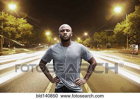 Time lapse view of Black runner standing on city street at night View Large Photo Image Stock Image - Time lapse view of Black runner standing on city street at night. Fotosearch