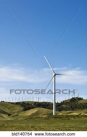 Wind turbines lining hilltop in rolling landscape View Large Photo Image Picture - Wind turbines lining hilltop in rolling landscape. Fotosearch