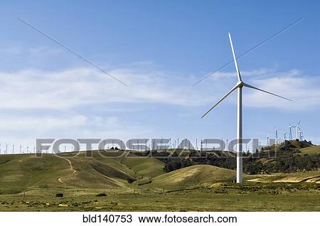 Wind turbines lining hilltop in rolling landscape View Large Photo Image Stock Image - Wind turbines lining hilltop in rolling landscape. Fotosearch