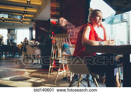 Woman relaxing in cafe View Large Photo Image Stock Image - Woman relaxing in cafe. Fotosearch