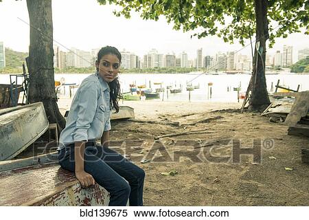 Stock Photography - Woman sitting on upside. Fotosearch