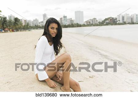 Woman sitting on urban beach View Large Photo Image Stock Image - Woman sitting on urban beach. Fotosearch