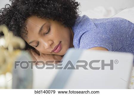 Stock Photo - Woman sleeping in bed. Fotosearch