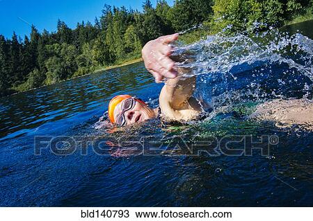 Woman swimming in lake View Large Photo Image Stock Image - Woman swimming in lake. Fotosearch