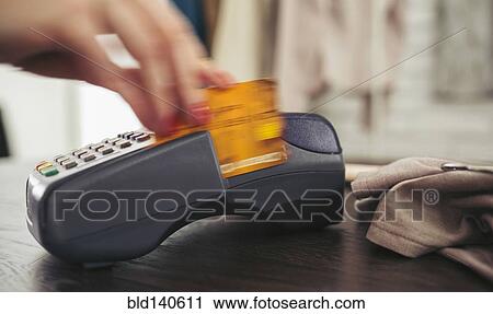 Woman swiping credit card through credit card reader View Large Photo Image Stock Image - Woman swiping credit card through credit card reader. Fotosearch