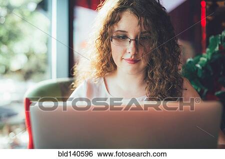 Stock Photograph - Woman using laptop computer. Fotosearch