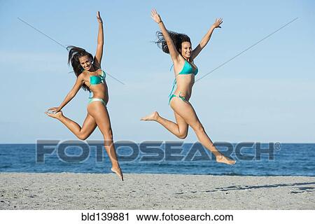 Women jumping for joy on beach View Large Photo Image Stock Image - Women jumping for joy on beach. Fotosearch