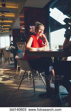 Women relaxing in cafe View Large Photo Image Stock Image - Women relaxing in cafe. Fotosearch