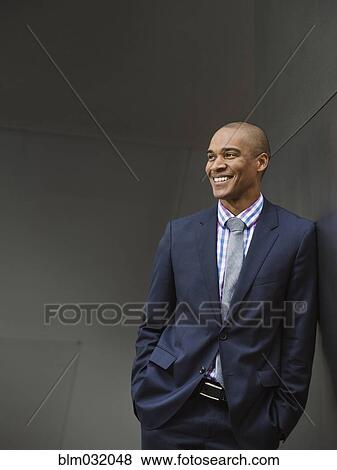 Stock Photo - Black businessman smiling. Fotosearch
