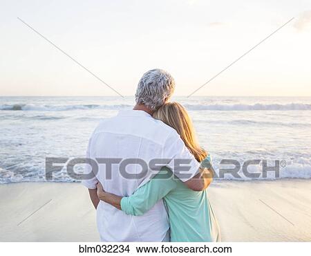 Caucasian couple hugging on beach View Large Photo Image Picture - Caucasian couple hugging on beach. Fotosearch