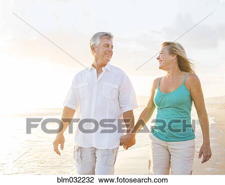 Caucasian couple walking on beach View Large Photo Image Stock Image - Caucasian couple walking on beach. Fotosearch