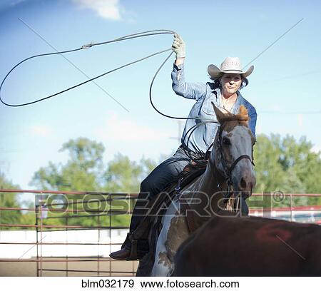 Caucasian cowgirl on horse throwing lasso on ranch View Large Photo Image Stock Photo - Caucasian cowgirl on horse throwing lasso on ranch. Fotosearch