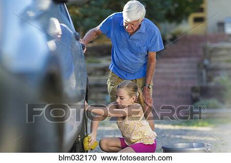 Caucasian grandfather and granddaughter washing car outdoors View Large Photo Image Stock Image - Caucasian grandfather and granddaughter washing car outdoors. Fotosearch