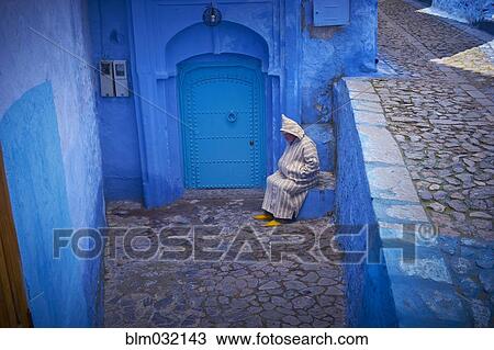 Caucasian hooded man sitting on colorful historical village steps, Chefchaouen, Chefchaouen, Morocco View Large Photo Image Stock Image - Caucasian hooded man sitting on colorful historical village steps, Chefchaouen, Chefchaouen, Morocco. Fotosearch