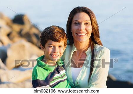 Caucasian mother and son smiling on rocky beach View Large Photo Image Stock Photograph - Caucasian mother and son smiling on rocky beach. Fotosearch
