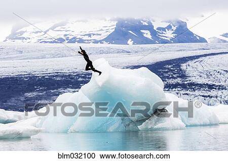 Caucasian surfer jumping into glacial water View Large Photo Image Stock Image - Caucasian surfer jumping into glacial water. Fotosearch