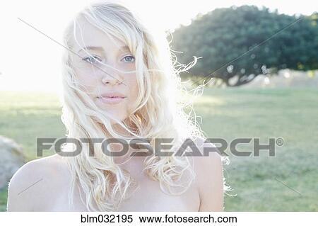 Stock Photography - Caucasian woman standing in field. Fotosearch