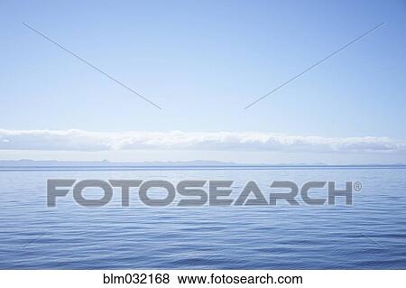 Stock Photo - Clouds over horizon and seascape. Fotosearch