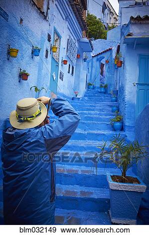 Man photographing blue historical village steps, Chefchaouen, Chefchaouen, Morocco View Large Photo Image Stock Photo - Man photographing blue historical village steps, Chefchaouen, Chefchaouen, Morocco. Fotosearch